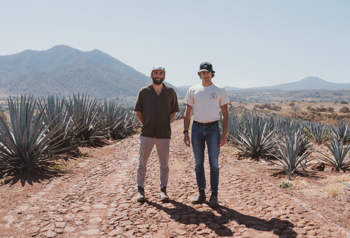 Co-owners of JuneShine standing in agave field.