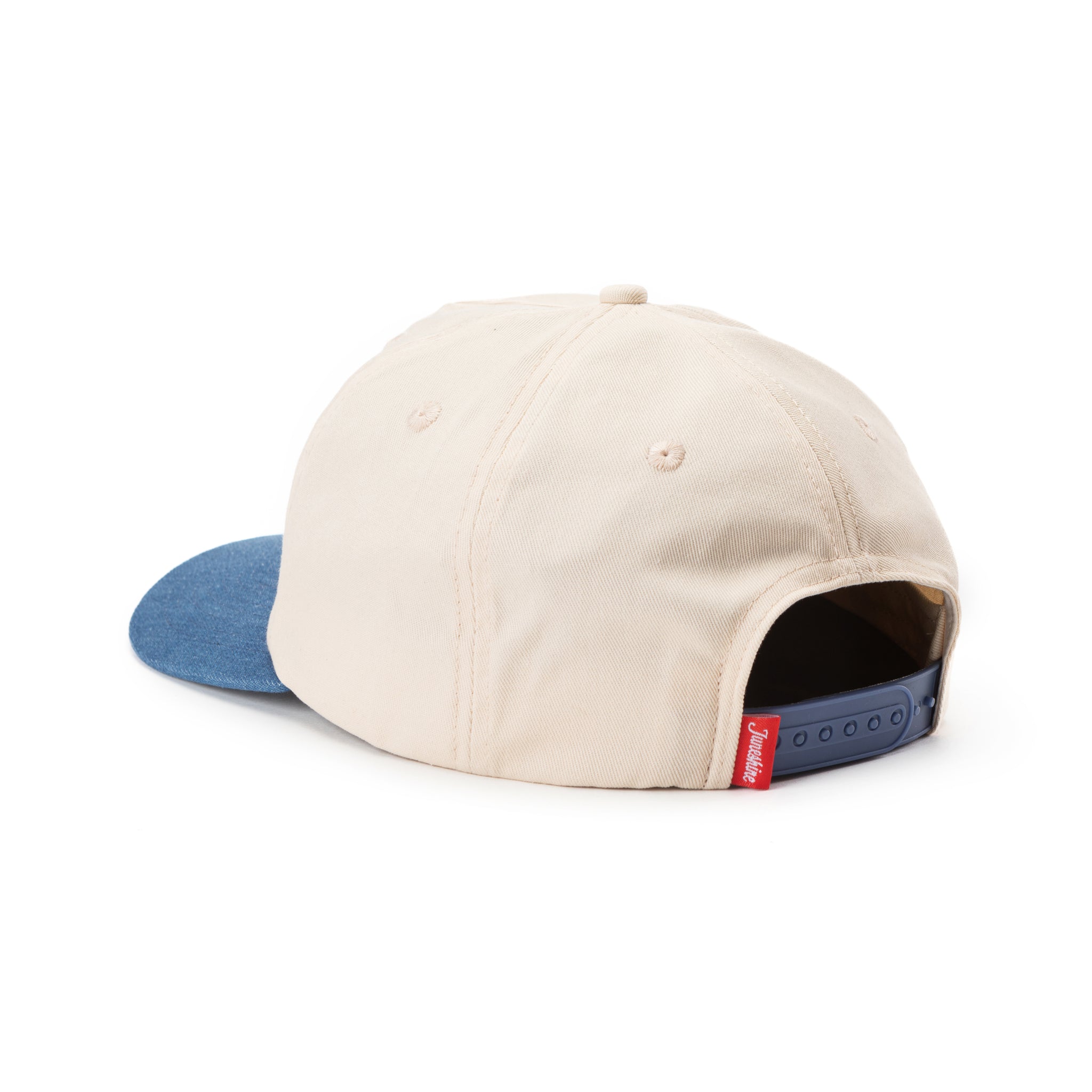 Back view of White hat with blue denim brim and blue snap back adjustment for sizing with a red tag that reads: June shine