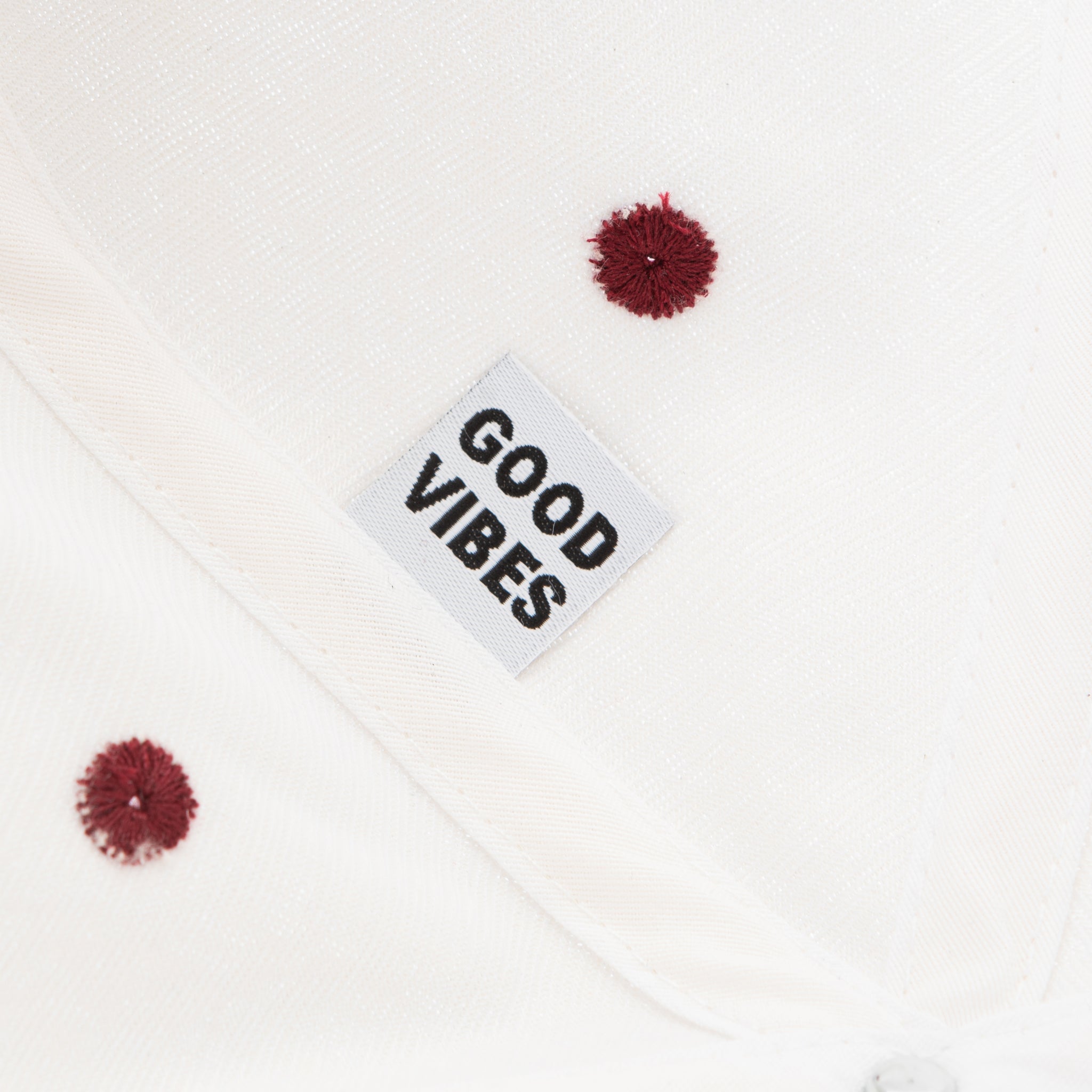 Close up of hat detail: tag that reads "good vibes"