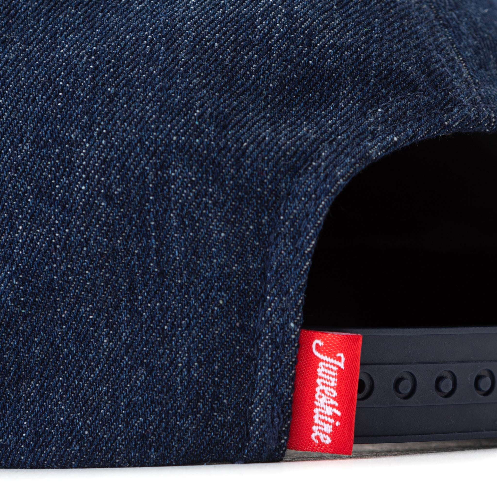 Detail of denim hat with red tag that reads JuneShine