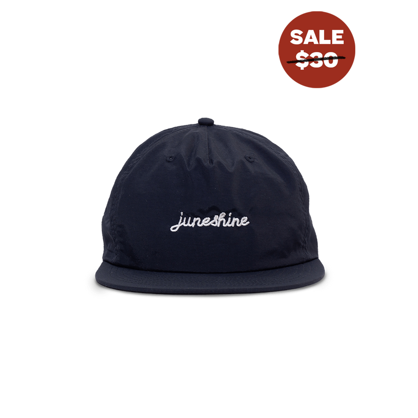 Front view of Navy blue hat with cursive embroidered writing that reads; june shine 
