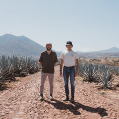 Co-owners of JuneShine standing in agave field.
