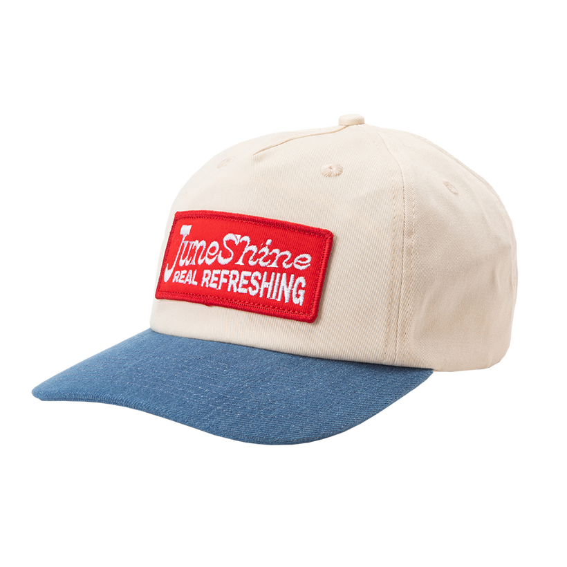 White hat with blue denim brim that includes a red patch sewn on the front that reads; June Shine Real REfreshing