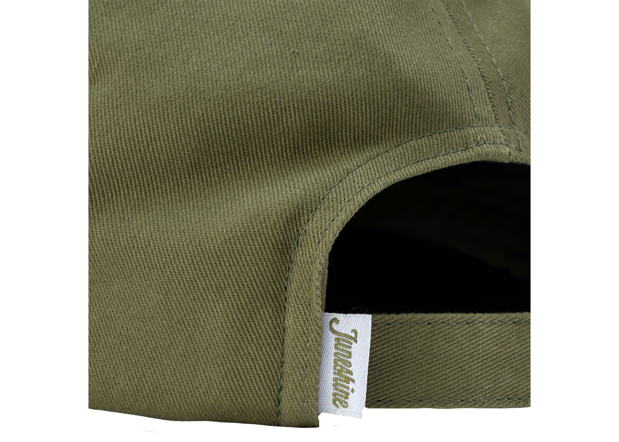 Close up image of back of green hat with adjustable strap and tag that reads: "June Shine"
