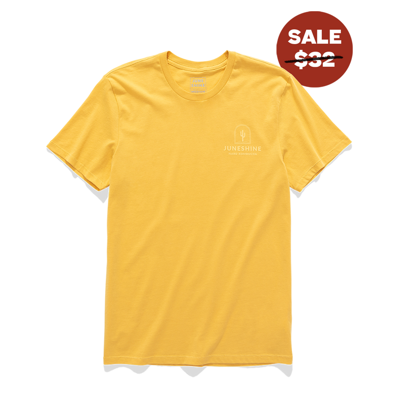 Front view of yellow tee shirt with graphic on the top left of a catus and test that reads 