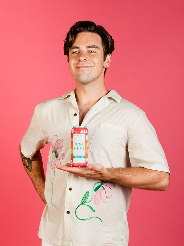 Cody Ko smiling while holding can of hippie juice